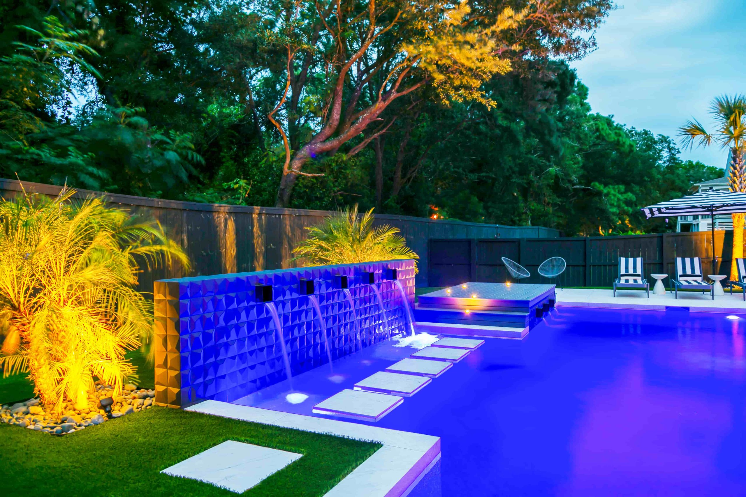 modern rectangular inground pool with spa, clean lines, and surrounding patio design