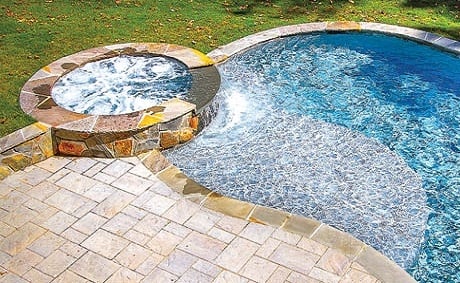 Freeform pool with bubbling spa Freeform pool with bubbling spa