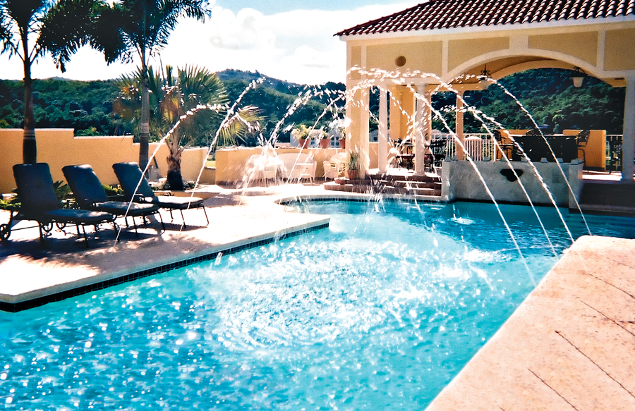Deck jets spraying water into rectangular pool