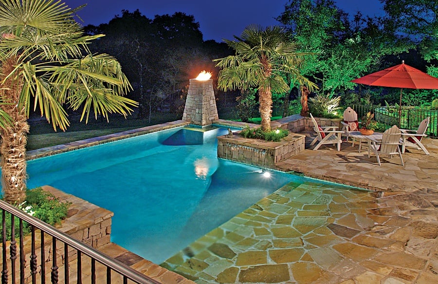 Flagstone beach entry pool built by Blue Haven Pools Flagstone beach entry pool at night