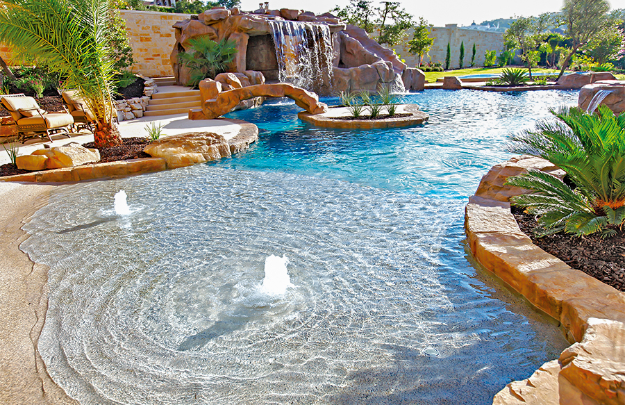 Lagoon-style tropical pool with beach entry and shallow tanning ledge