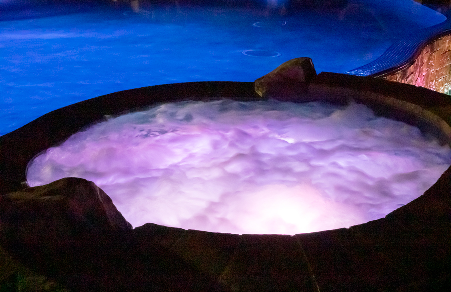 Lit custom spa with jets on creating a glowing diffused LED effect at night