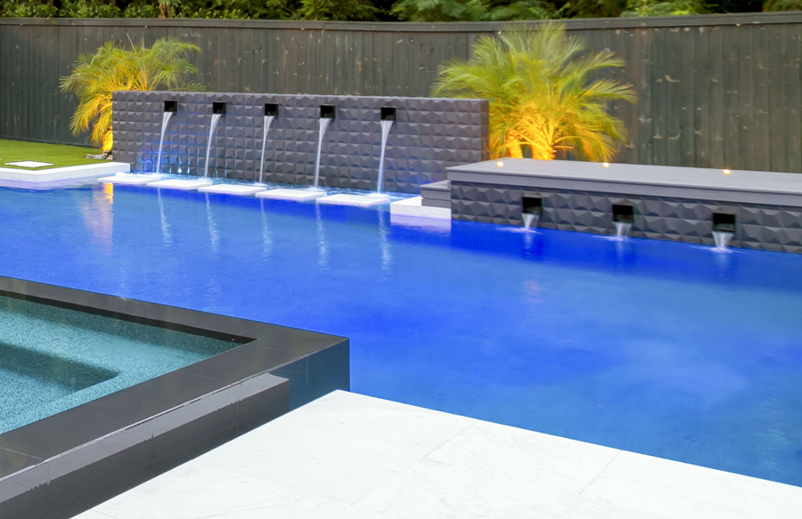 Stainless steel scuppers on pool wall