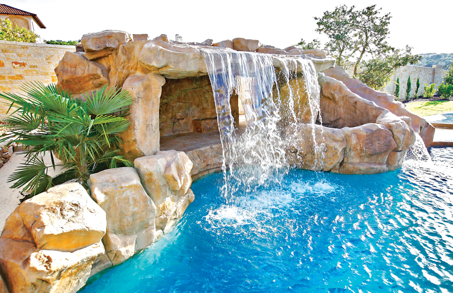 Pool grotto with cave under waterfall