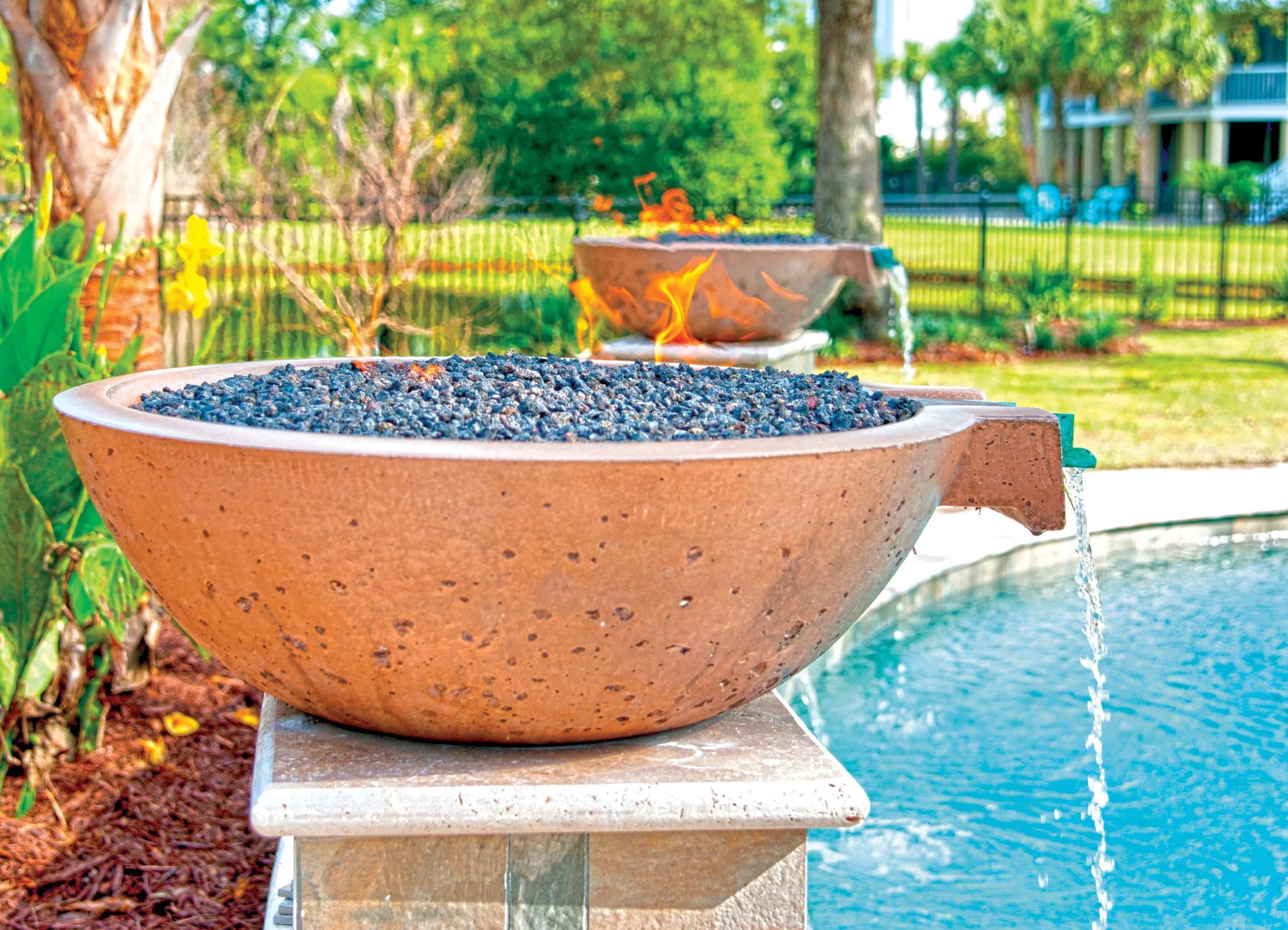 poolside fire and water bowl feature on raised pedestal