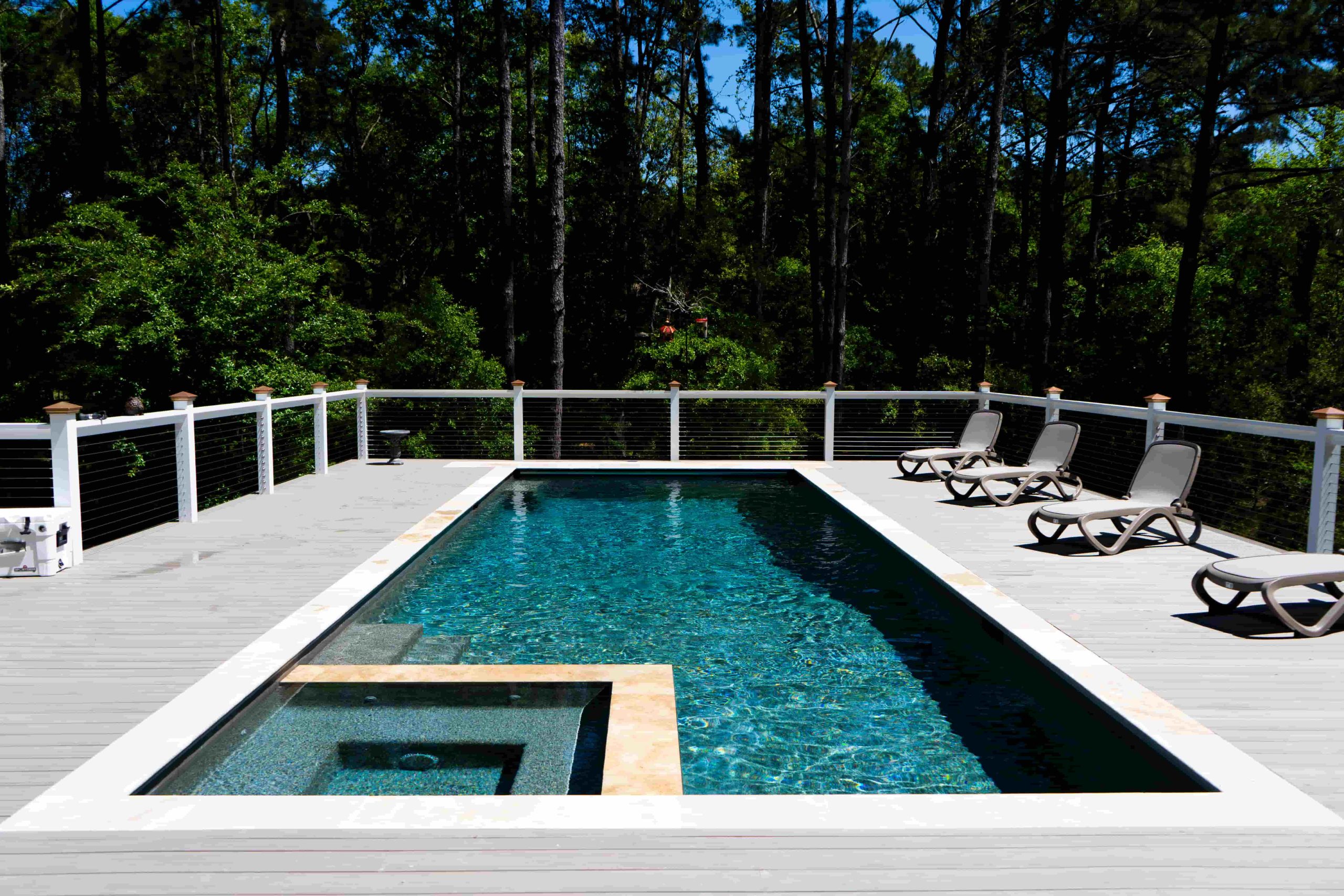 rectangular pool with modern paver decking and contrasting coping