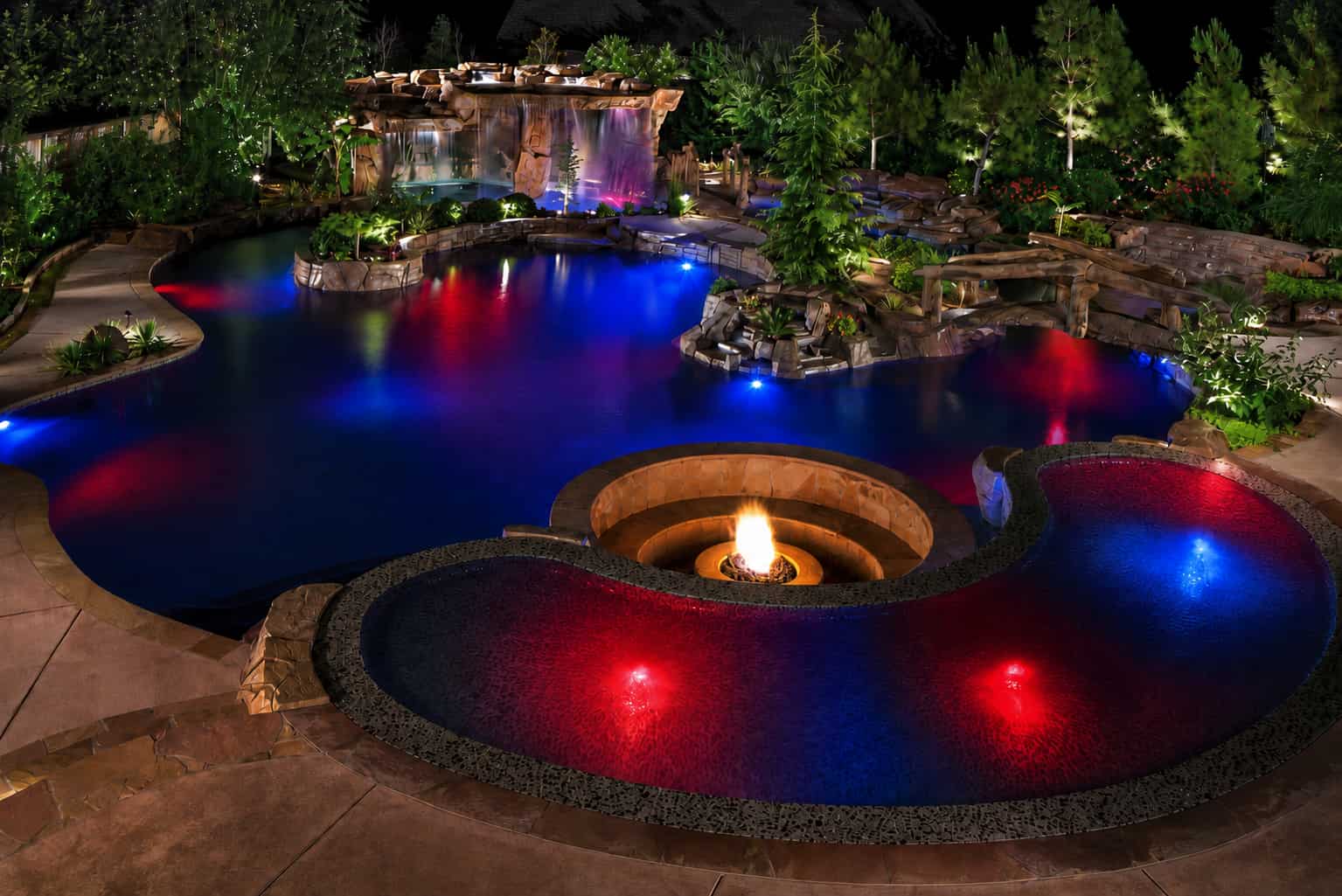 Backyard pool lit red and blue with Bluehaven SmartLight LED for a 4th of July celebration.