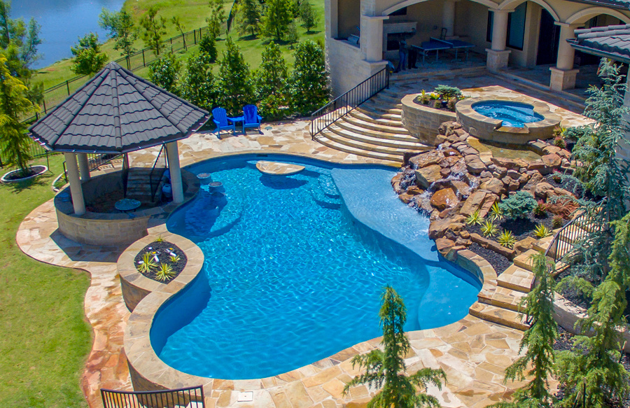 multi-level-deck-with-spa-and-rock-waterfall-above-custom-pool