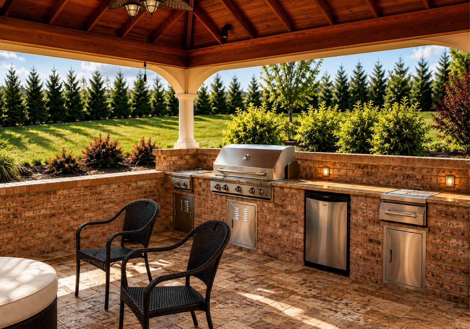 Built-in outdoor kitchen island with stainless steel grill under a wood gazebo