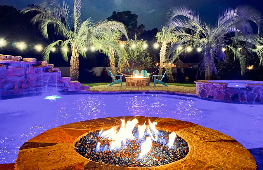 Gunite pool with purple LED lighting at night