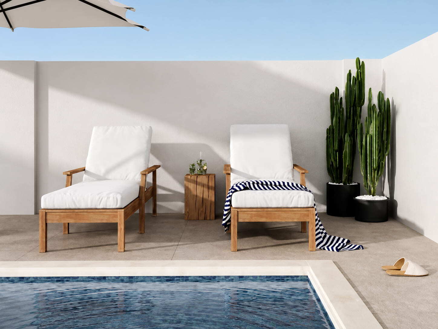 Pool patio with lounge chairs enclosed by a solid masonry privacy wall