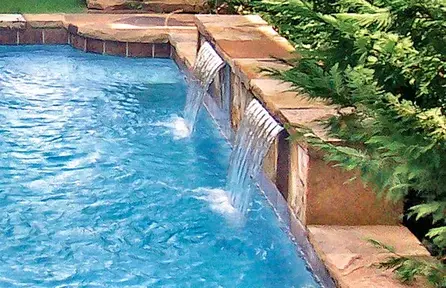 small pool with raised wall and cascade water features for vertical design