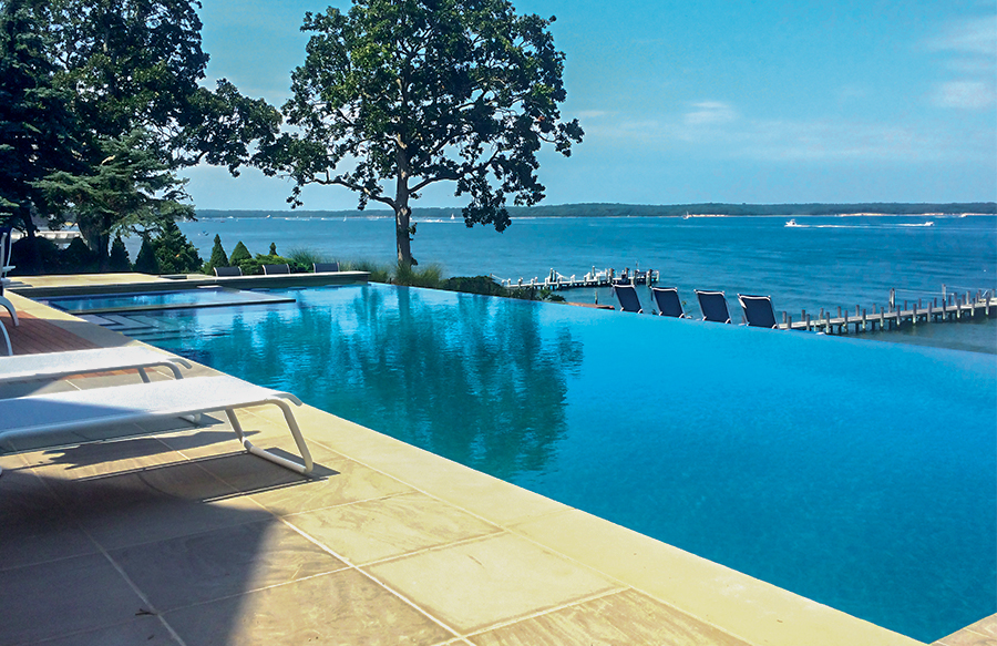 rectangular infinity edge pool with raised design and water overflow