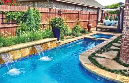 small backyard pool design with narrow layout, raised wall, and sheer descent waterfalls