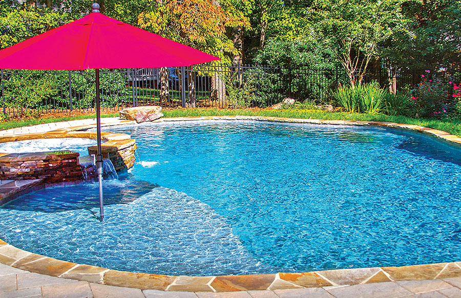 pool tanning ledge with red umbrella