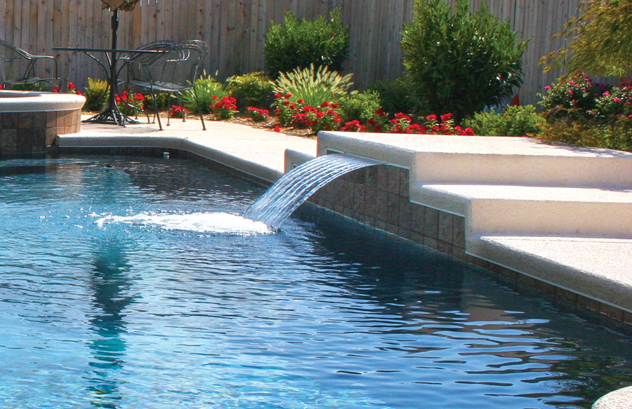 raised-bond-beam-with-cascade-watfall-over-swimming-pool