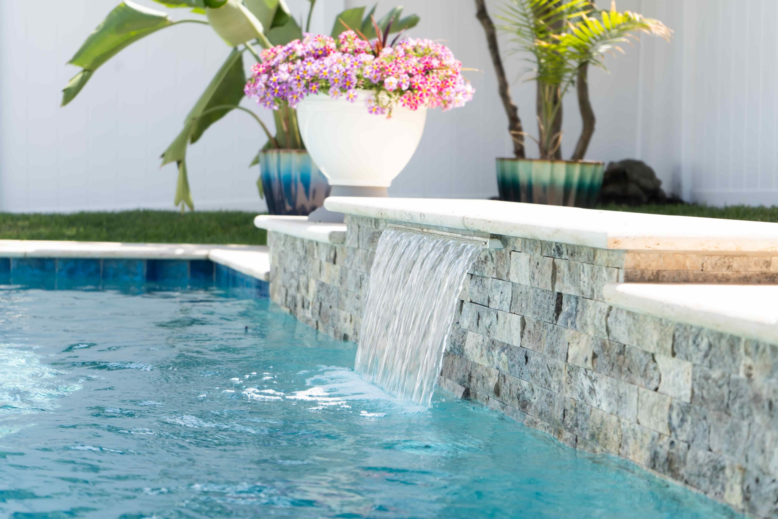 rectangular pool with raised wall and sheer descent waterfall feature