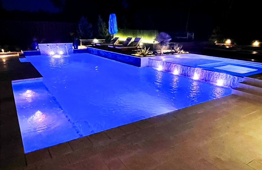 Color changing LED lights in modern backyard pool