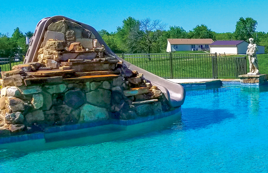 rock-waterfall-installed-around-deck-mounted-slide