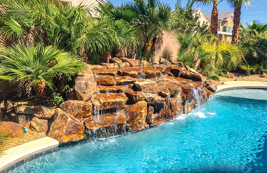 Natural stone waterfall feature on freeform pool