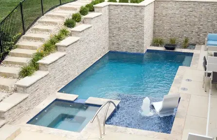 small geometric pool in tight backyard with raised retaining walls for space efficiency