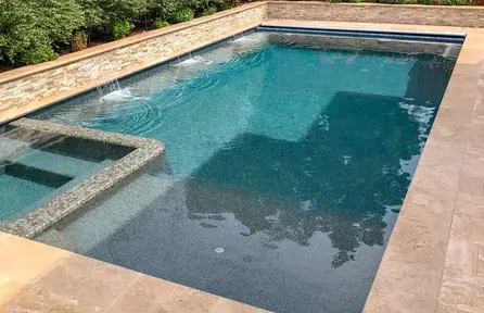 small rectangular pool with attached square spa and clean geometric design