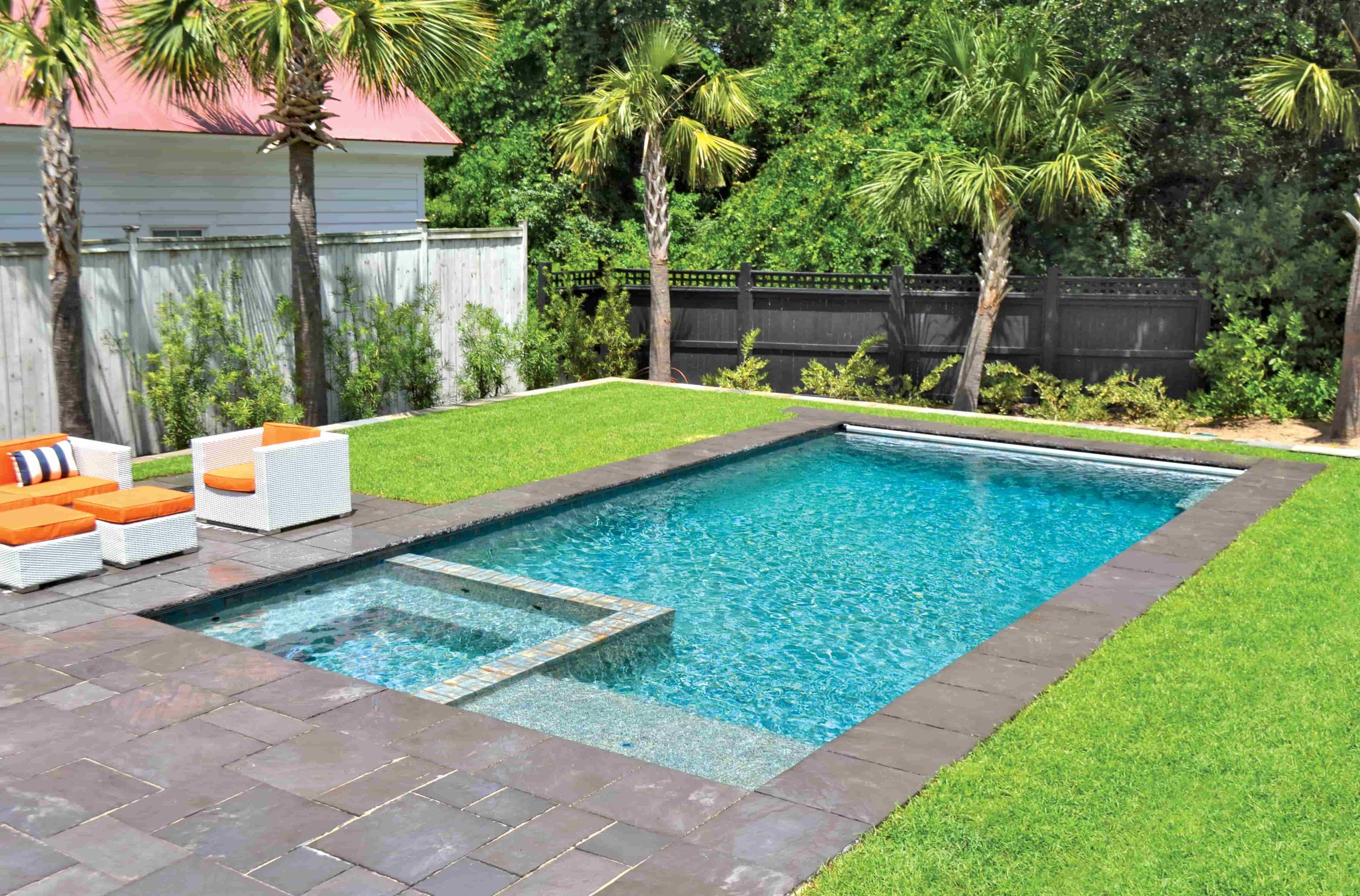 rectangular pool with attached raised spa and spillover feature