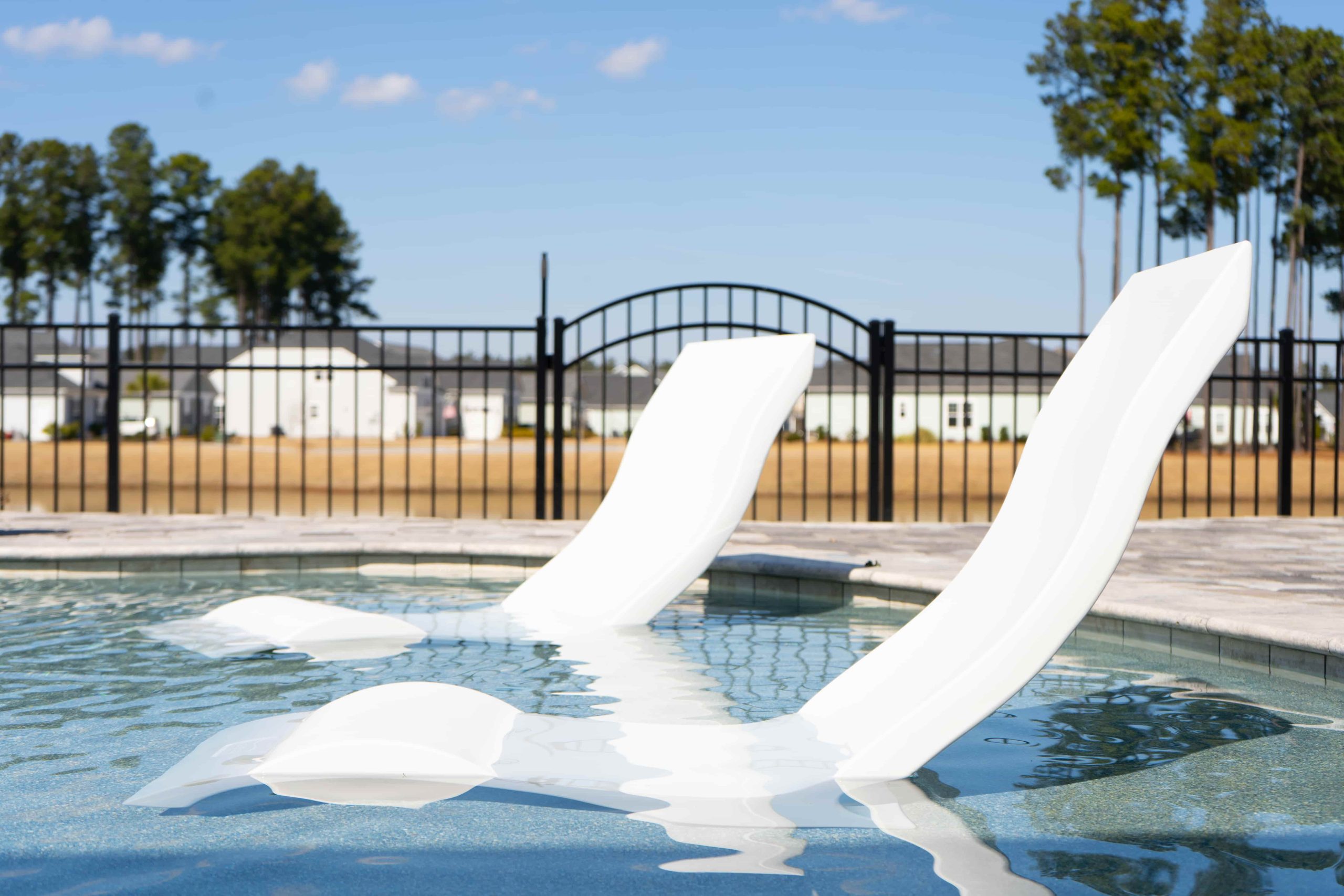 rectangular pool with tanning ledge and in-water lounge chairs